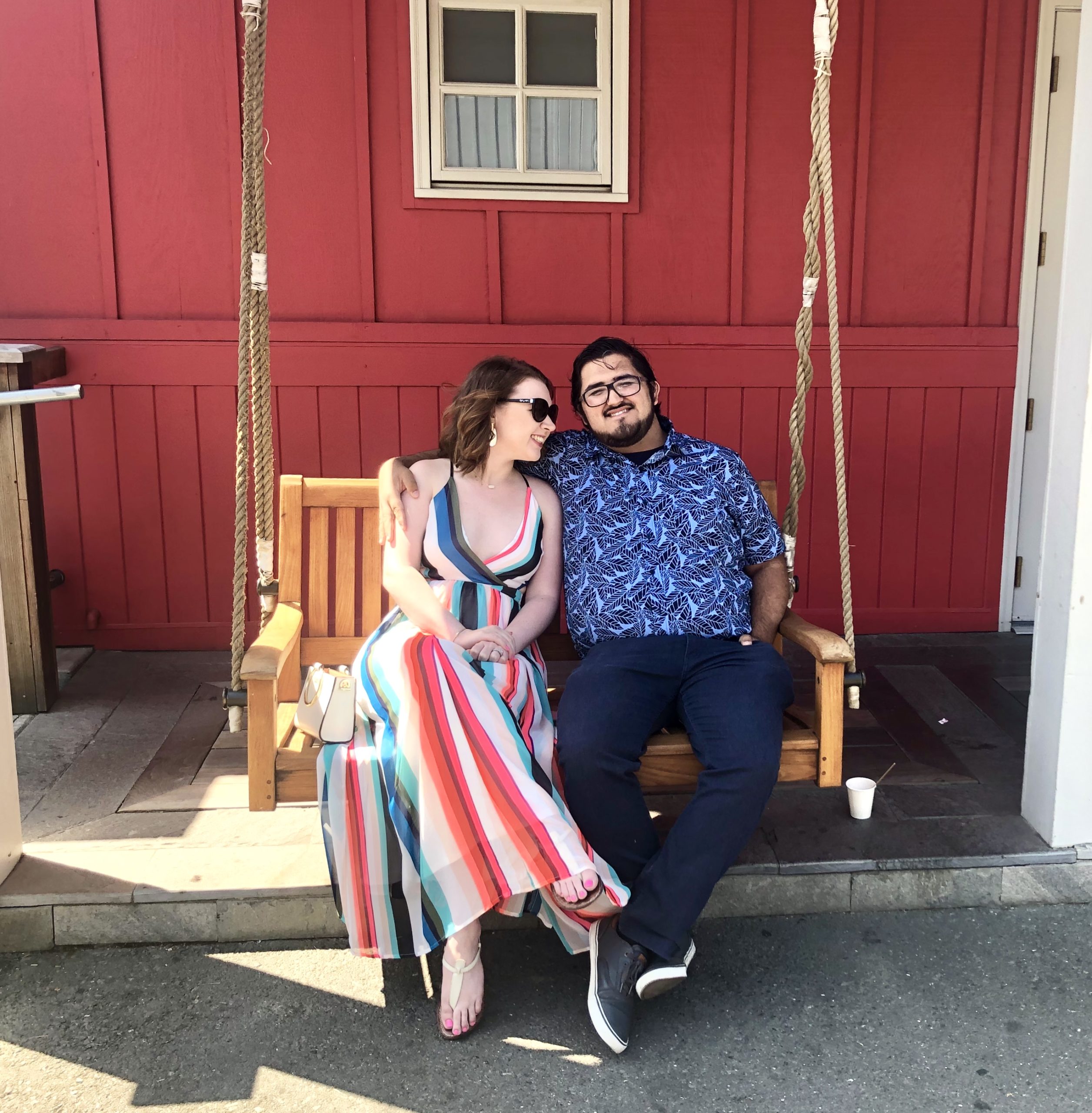 Couple sitting outside Boonfly Cafe Red Wall in Napa Valley Honeymoon