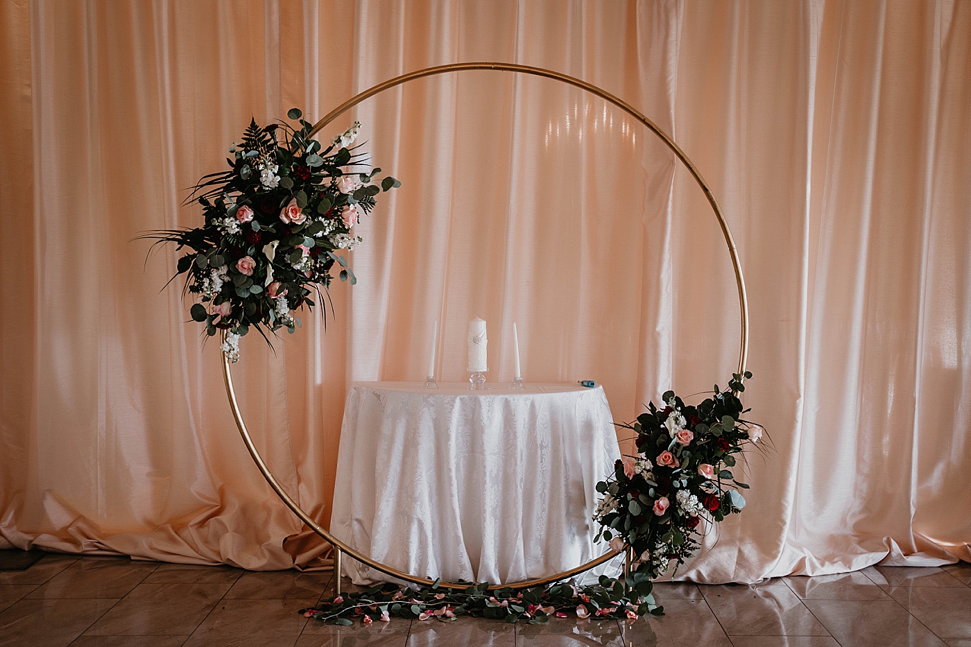 Ceremony detail shot of circular hoop alter with floral decor and candle unity table Romantic Winter Wedding captured NYC Wedding Planner Poppy and Lynn 