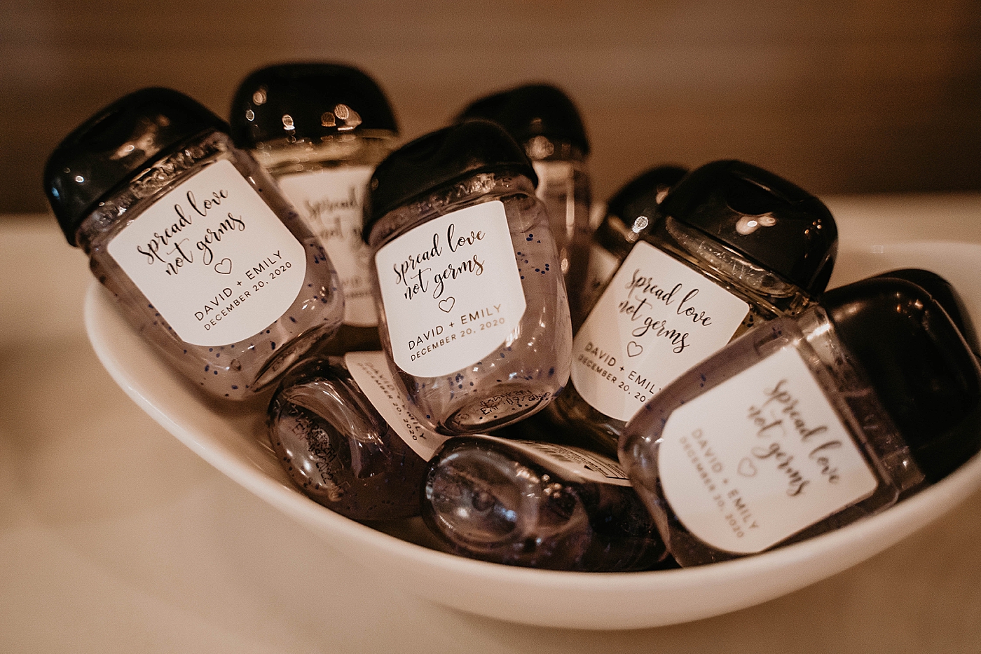 Personalized hand sanitizer bottles with "spread love not germs" printed on them stay safe covid-19 Romantic Winter Wedding captured NYC Wedding Planner Poppy and Lynn