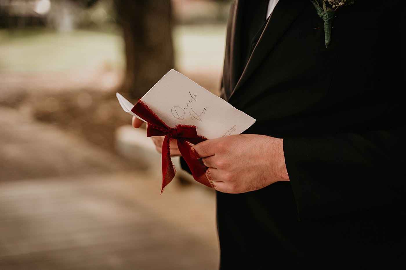 Closeup shot of Groom holding personal vow book Romantic Winter Wedding captured NYC Wedding Planner Poppy and Lynn