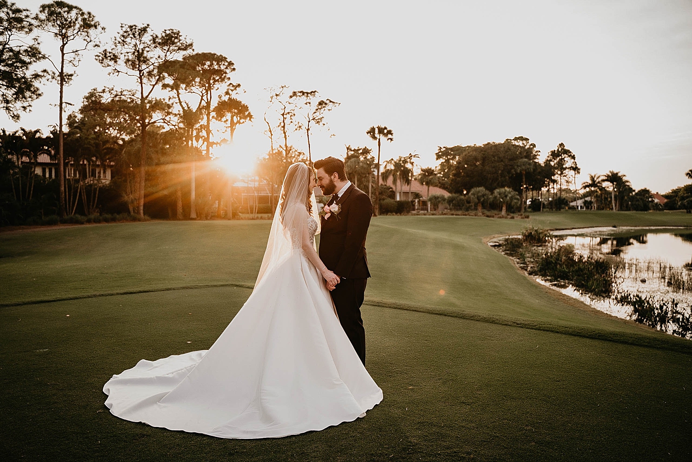 Bride and Groom touching noses as the sun sets on golf course green Romantic Winter Wedding captured NYC Wedding Planner Poppy and Lynn
