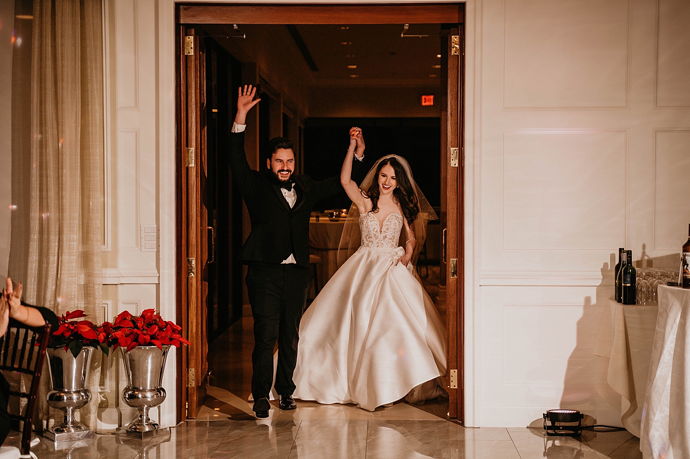 Bride and Groom triumphantly entering indoor Reception Romantic Winter Wedding captured NYC Wedding Planner Poppy and Lynn