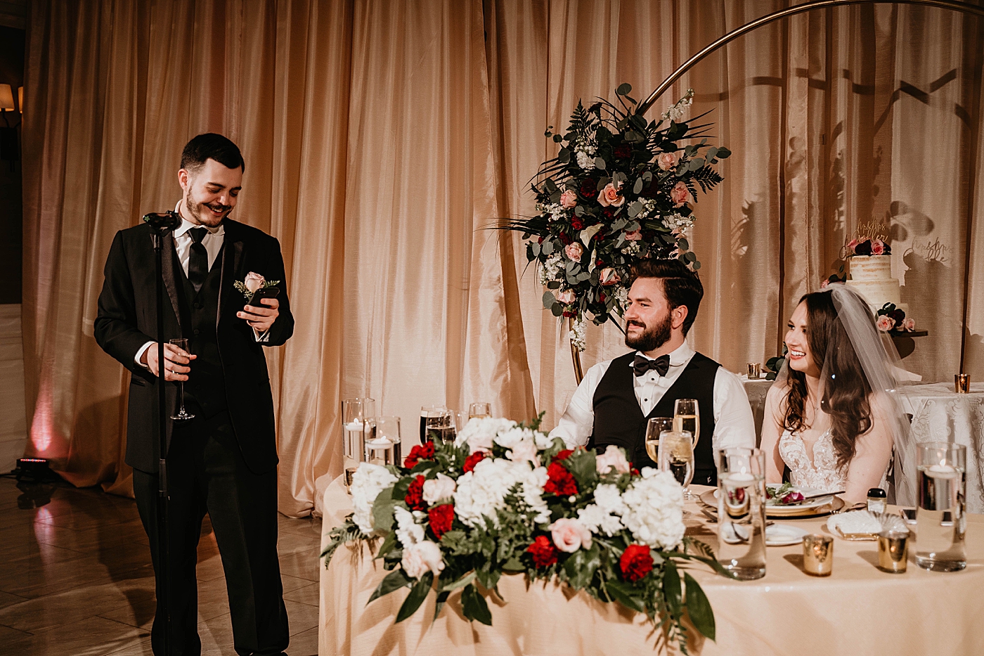 Best man speech by sweetheart table with happy Bride and Groom Romantic Winter Wedding captured NYC Wedding Planner Poppy and Lynn