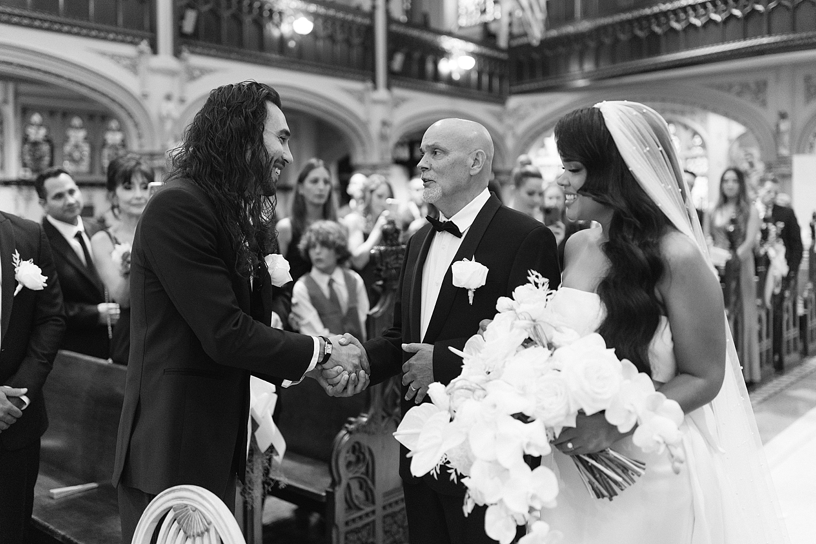 B&W Groom shaking Father of Bride at the alter for Ceremony