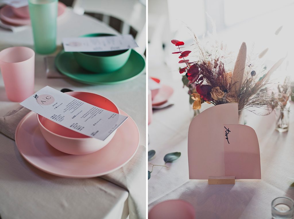 Detail shot of pink and green plate settings and floral center piece with paper design