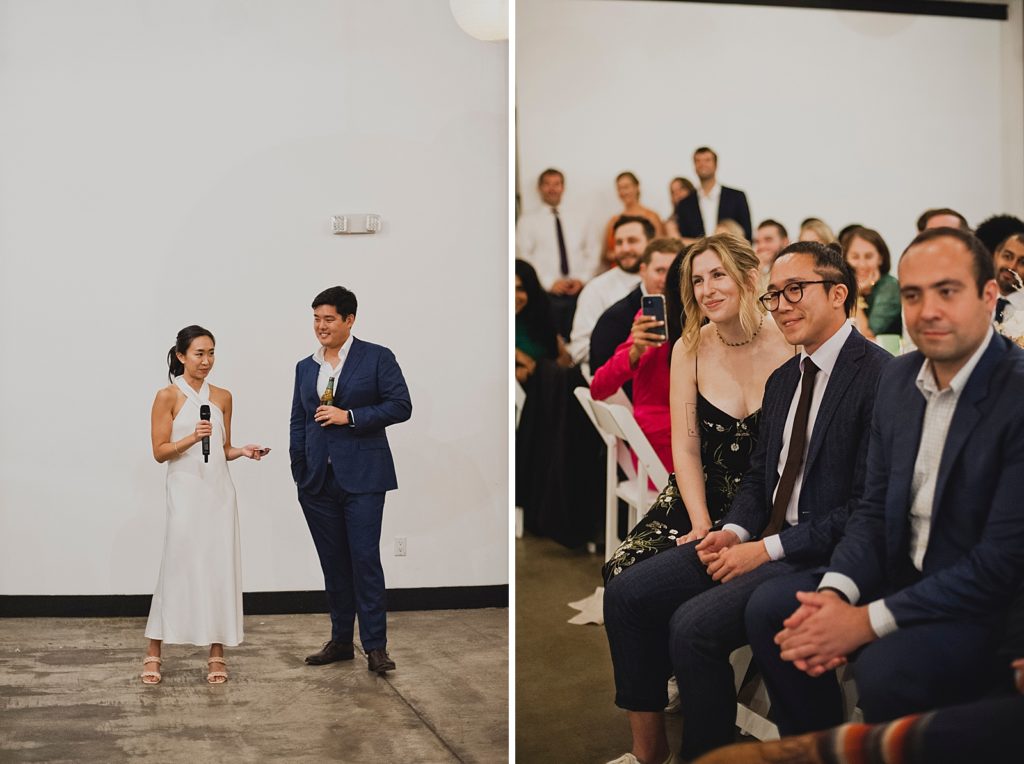 Bride giving speech at Reception with Groom next to her with beer in hand with guests listening