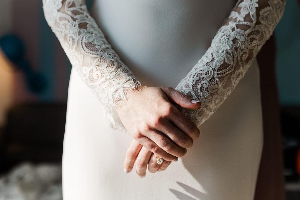 Closeup of Bride in wedding dress with arms crossed in front of body