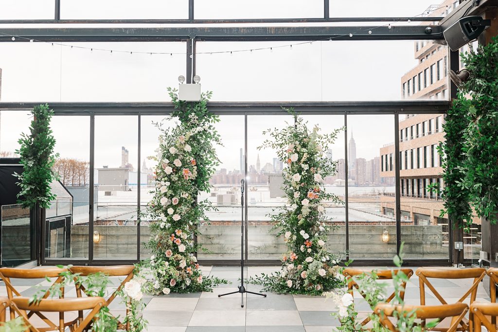 Detail shot of Ceremony with Manhattan view behind and greenery and flowers