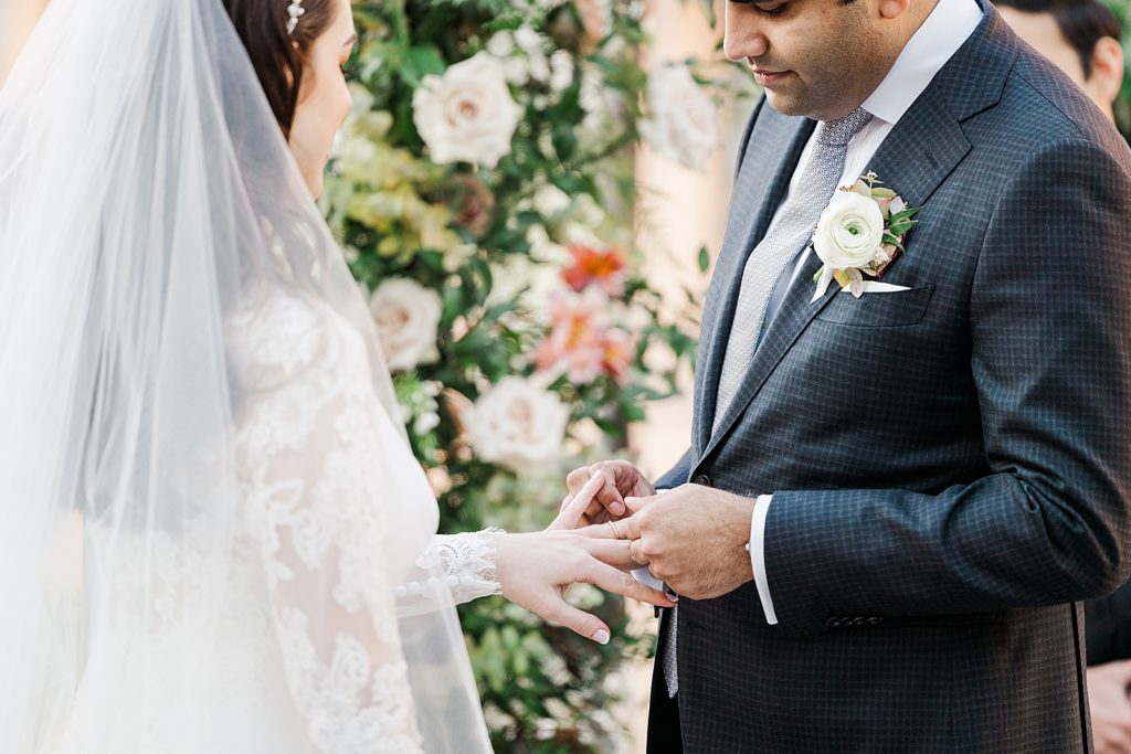 Closeup of Groom putting ring on Bride's finger for Ceremony