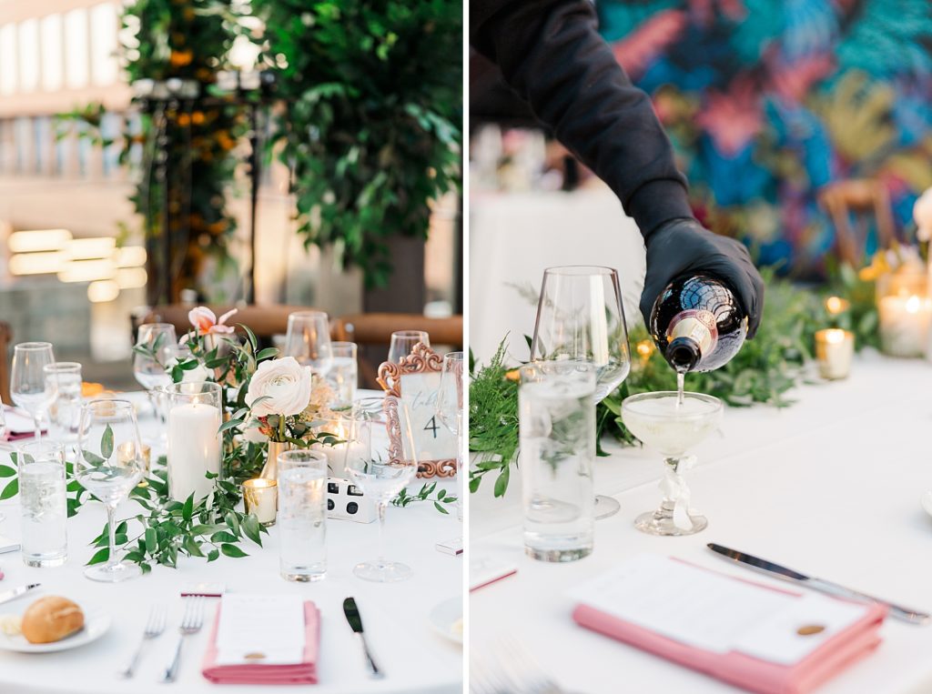 Detail shot of white Reception table with glasses and pink napkins and waiter pouring Champaign