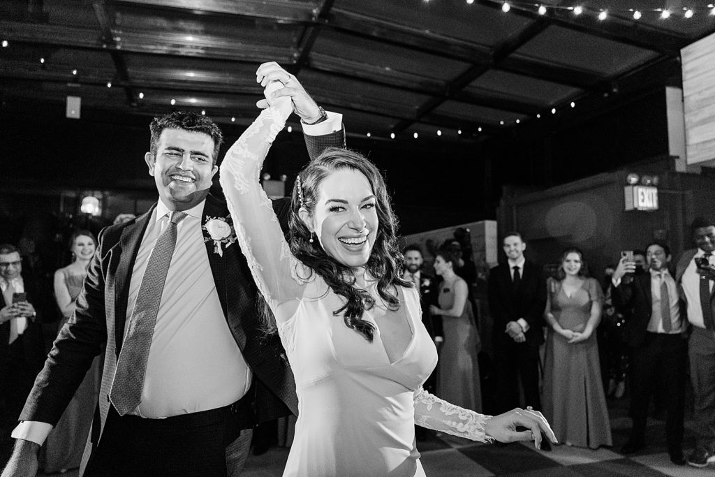 B&W Bride twirling by Groom's hand for First Dance at Reception