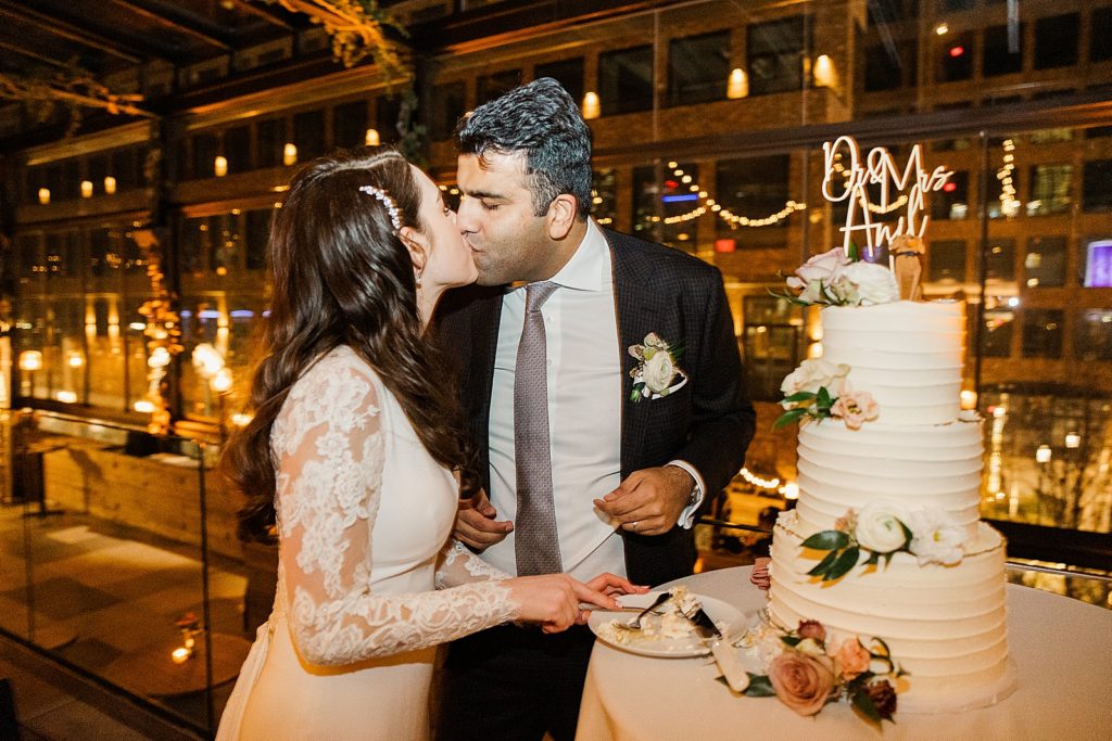 Bride and Groom kissing after first bite of cake