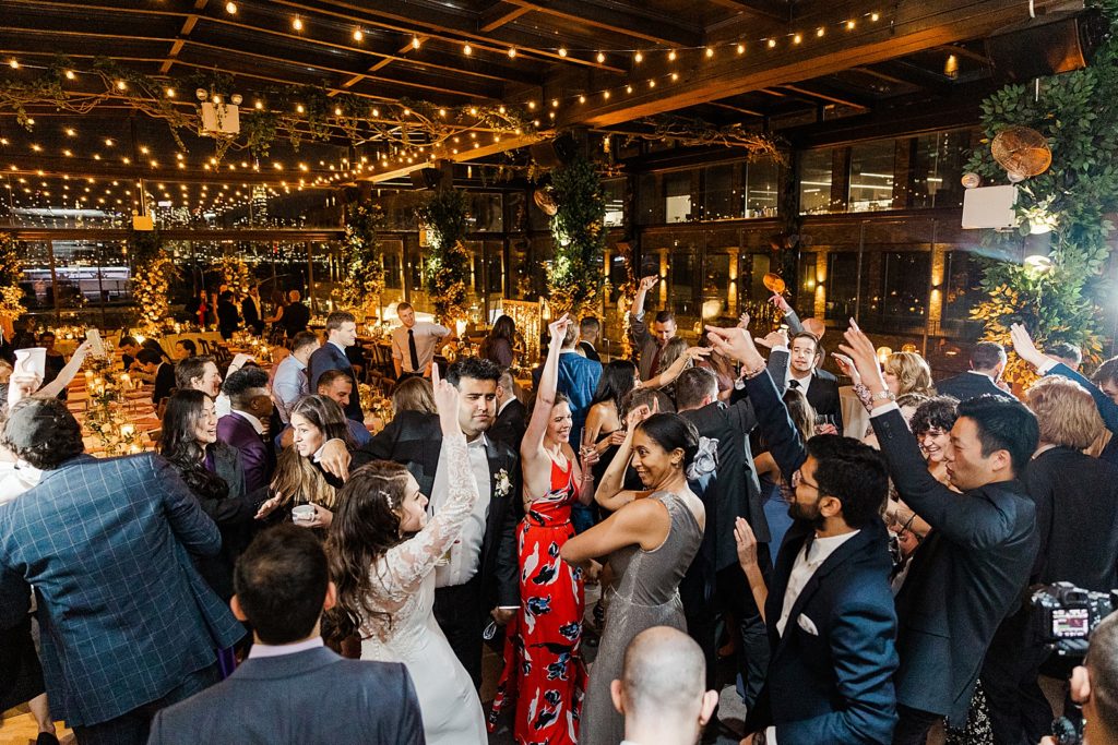 Wide shot of wedding guests dancing at Reception