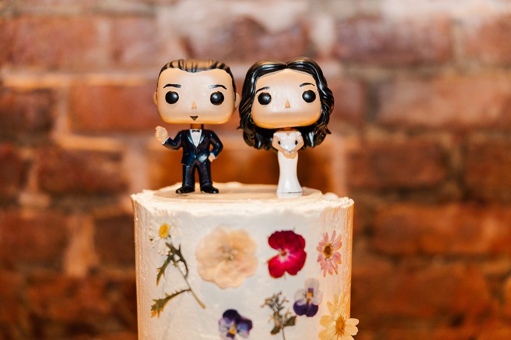Closeup detail shot of Bride and Groom Pop figure wedding cake toppers