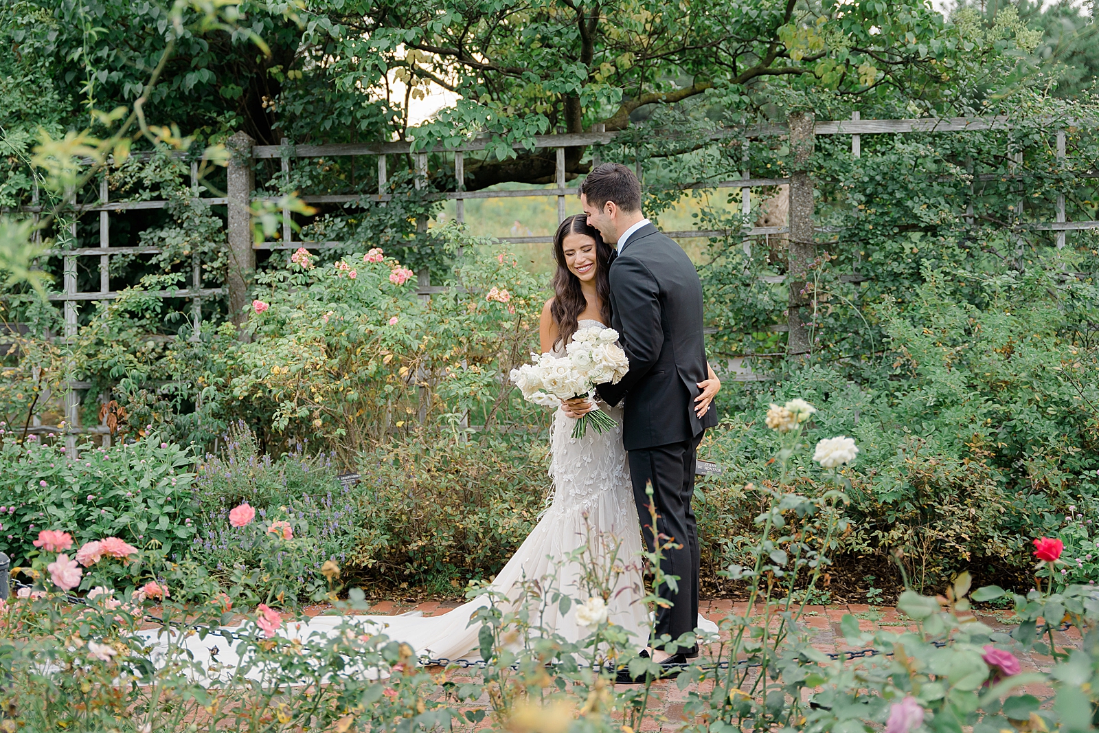 Shot of the bride and groom embracing in a garden. 