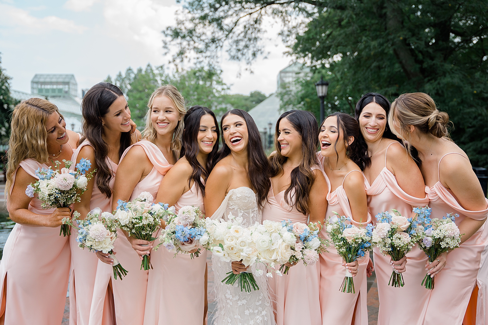 Shot of the bride with her bridesmaids as they smile and laugh together. 