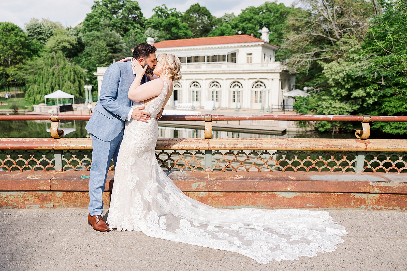 Shot of MK and Eliseo sharing a passionate kiss in front of Prospect Park Boathouse during their first look. 