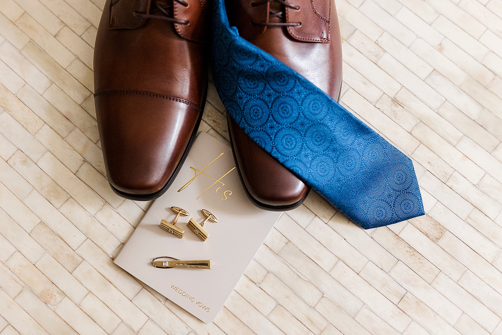 Photo of Eliseo's dress shoes, blue tie, and cuff links. 