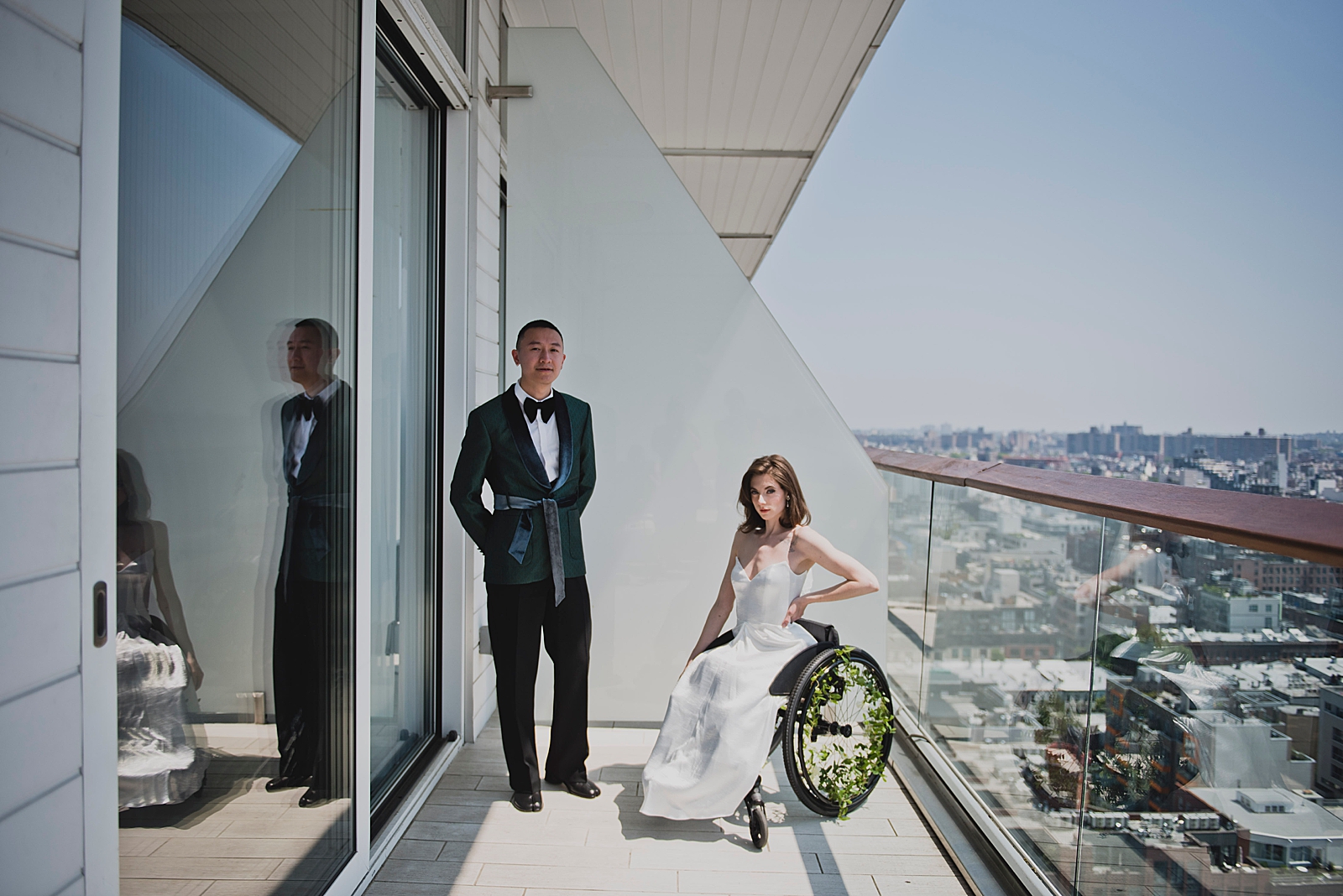 Shot of the bride and groom posing on a balcony. 