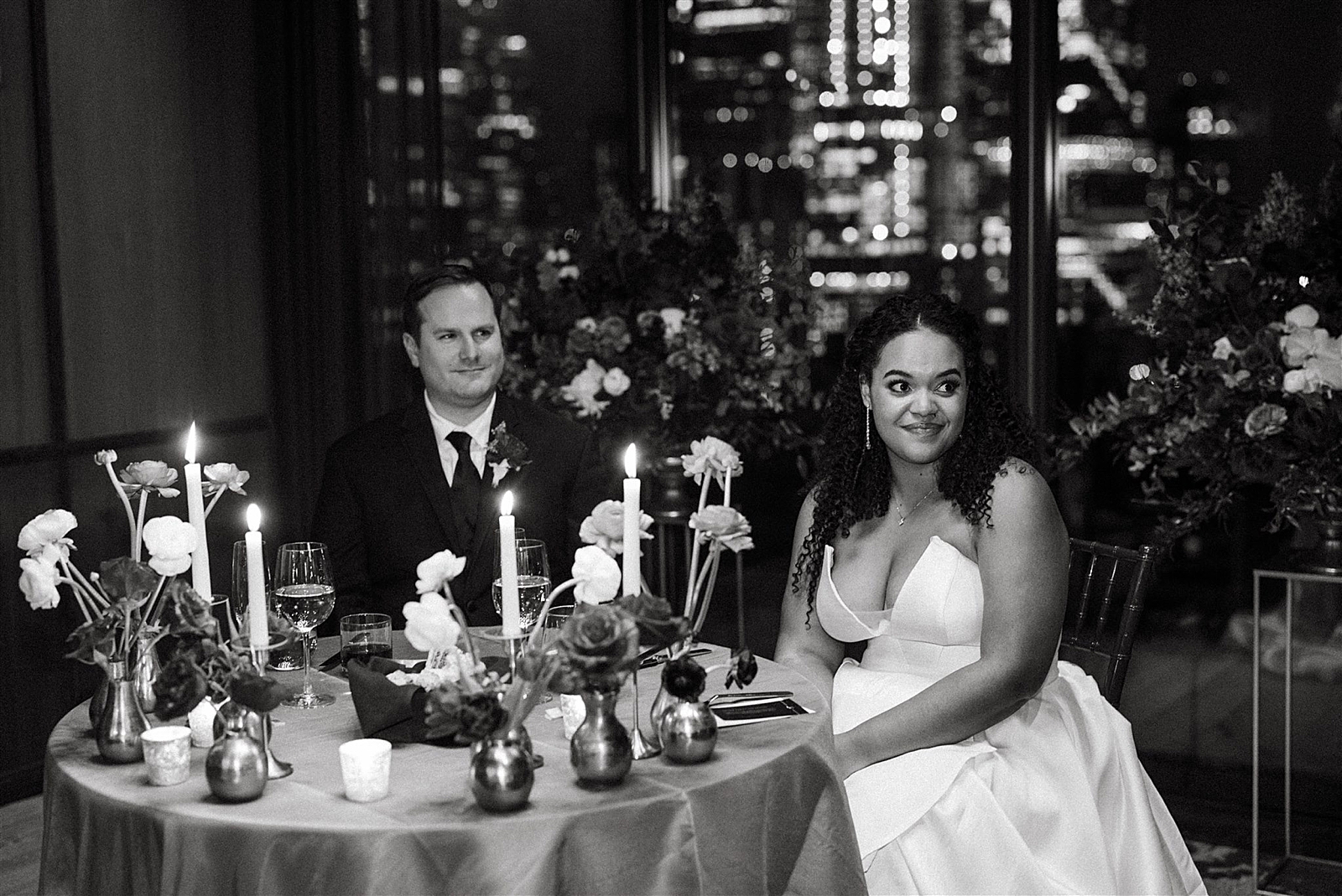 Shot of the Bride and Groom as they sit at their sweetheart table. 
