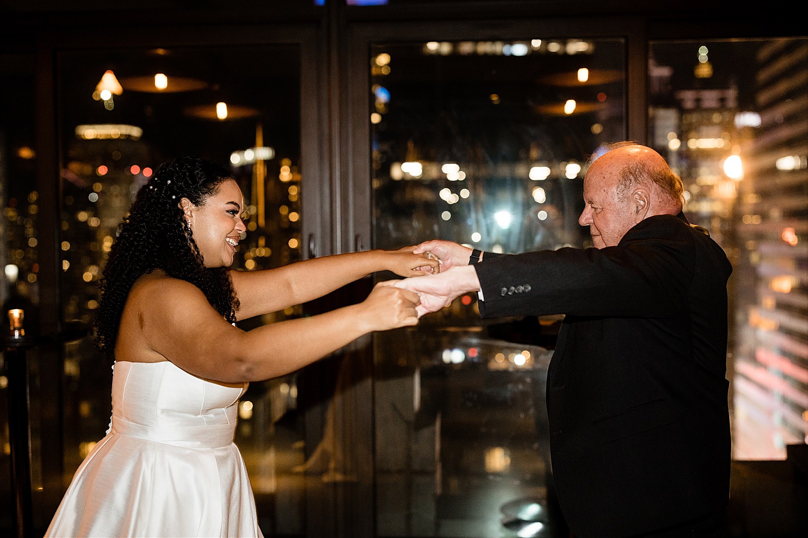 Shot of the bride dancing with a wedding guest. 