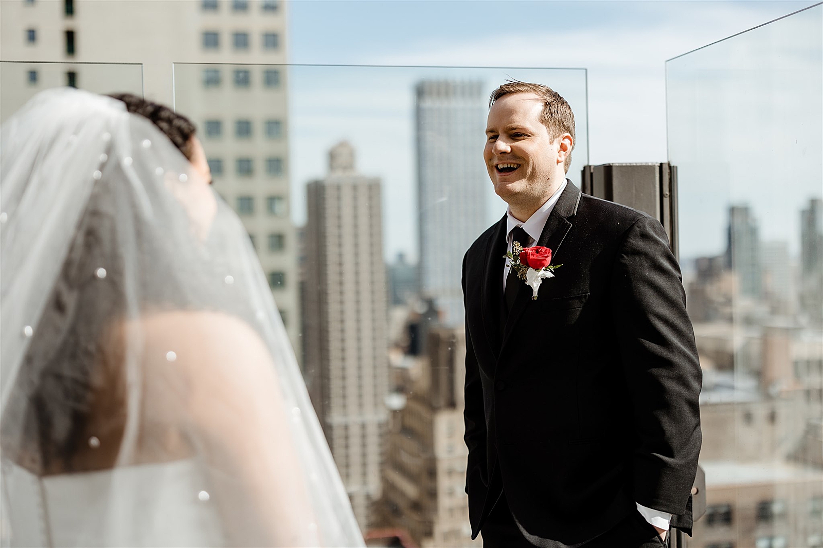 Groom is all smiles as he sees his bride for the first time during their first look on the roof of the Skylark. 