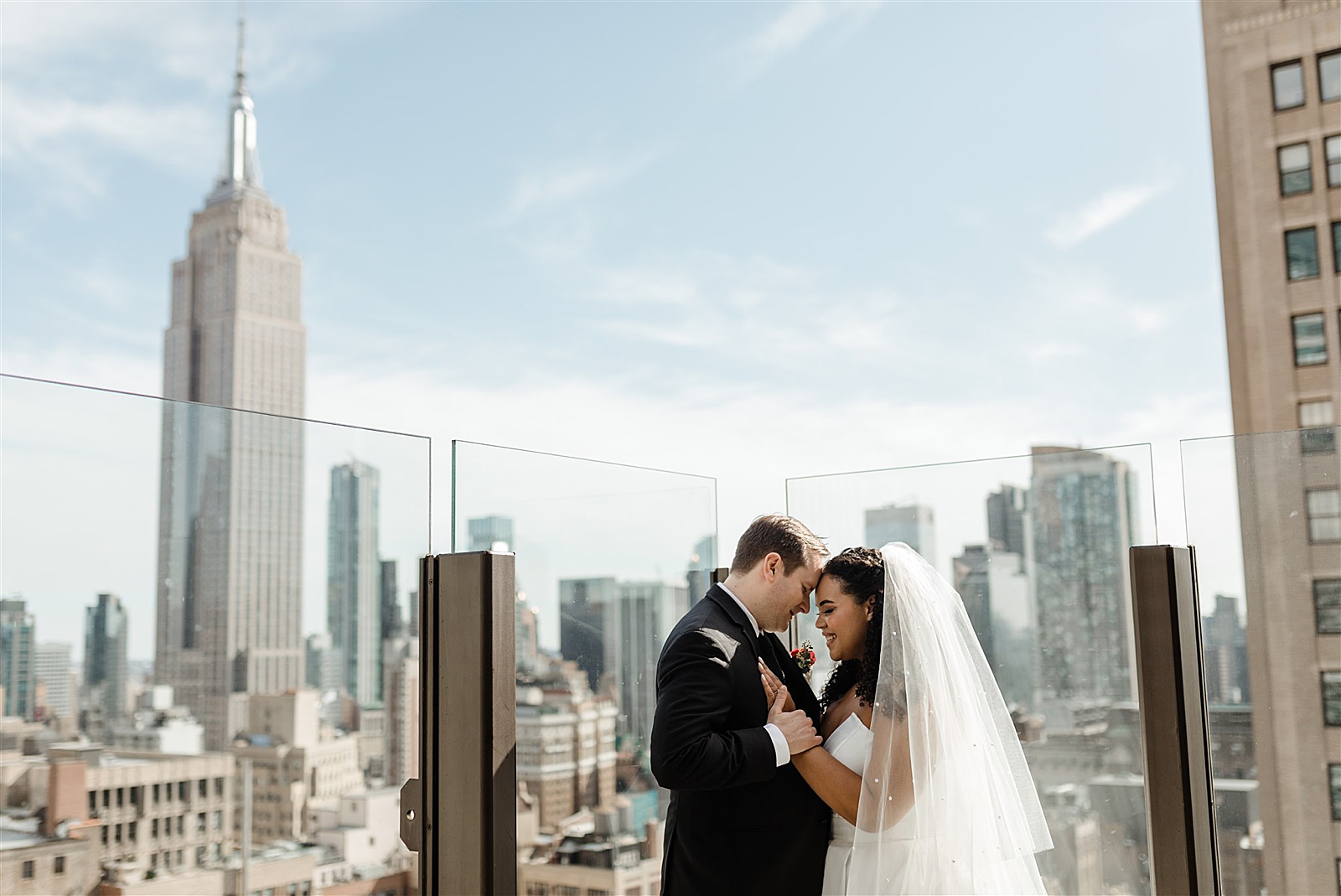 Bride and Groom embrace of the roof of the Skylark as the Empire State Building stuns in the background.