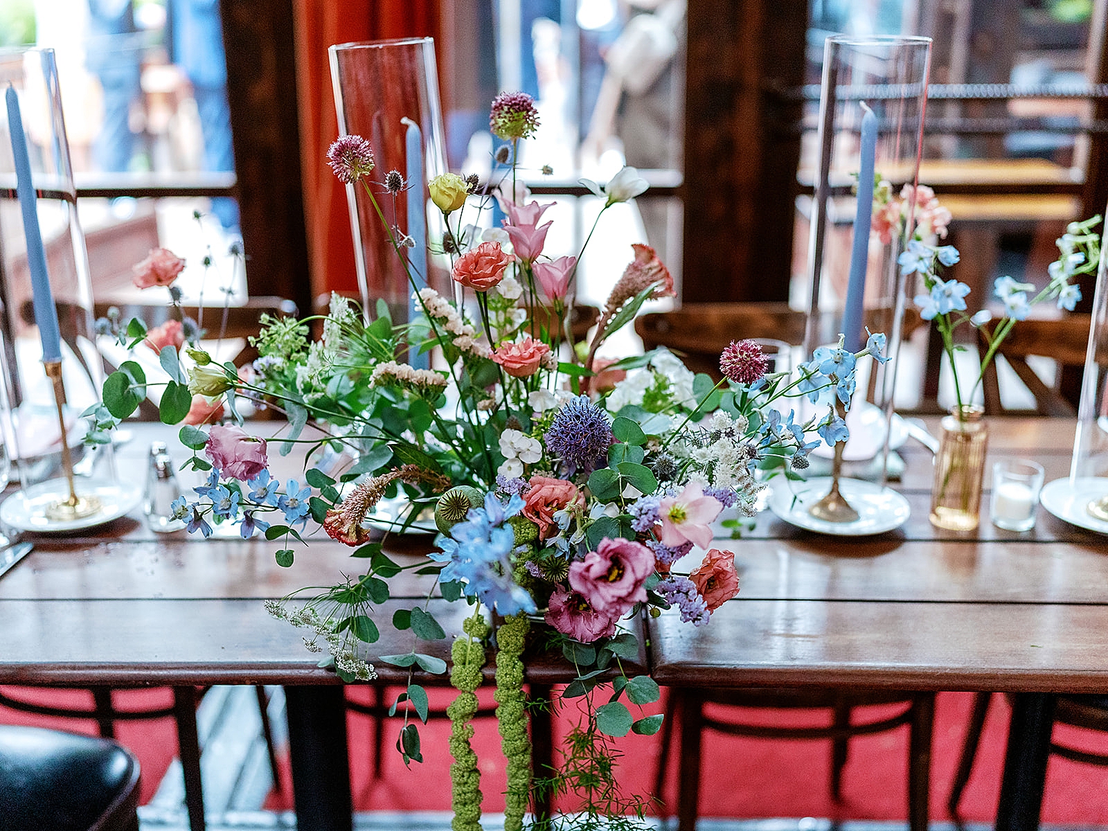 Close up shot of a floral arrangement on a reception table. 