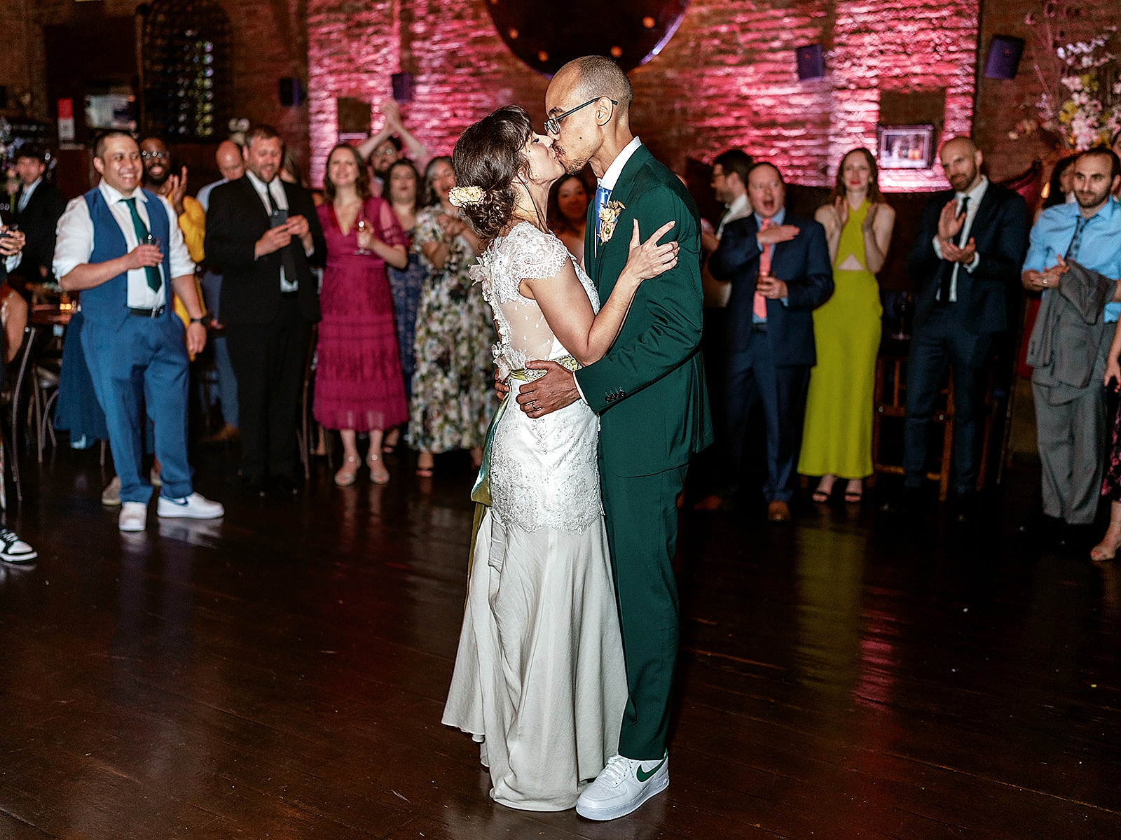 Full shot of the bride and groom sharing a kiss during their first dance.