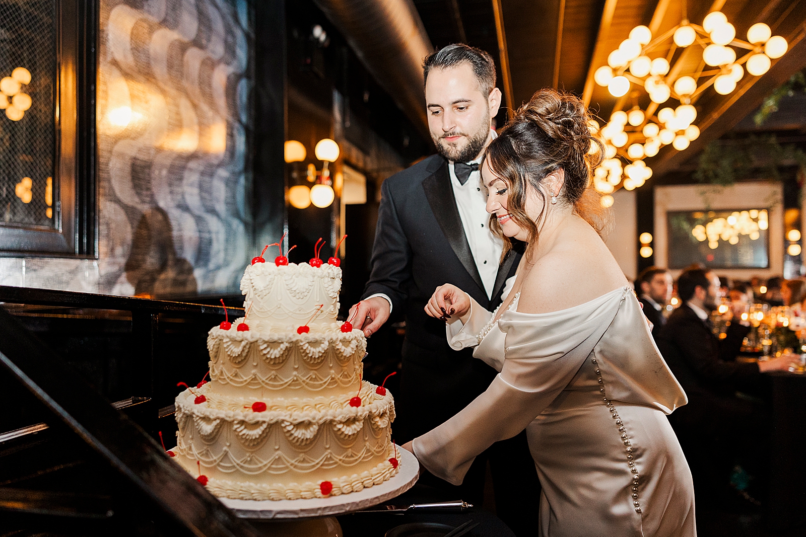 Up close shot of the couple cutting their wedding cake. 