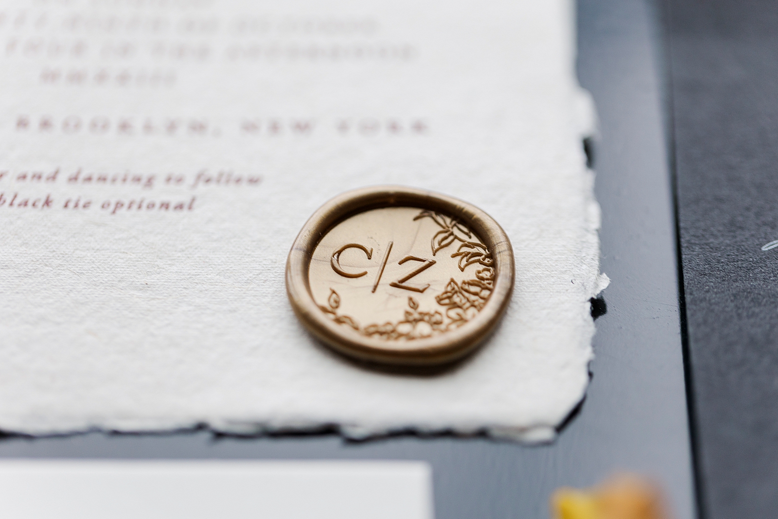 Close up shot of the couple's custom wax seal. 