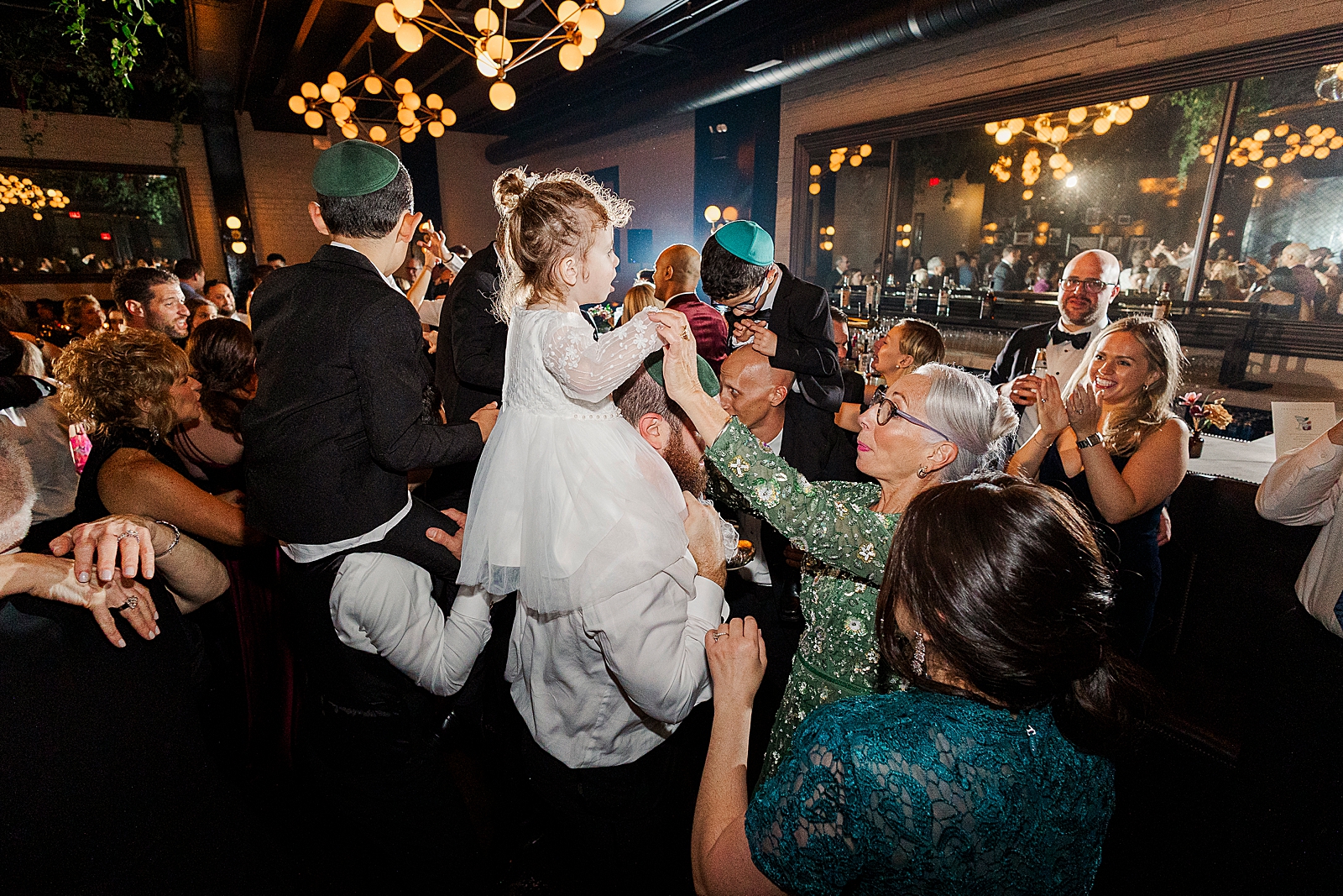Shot of the couple's friends and family dancing during the reception. 