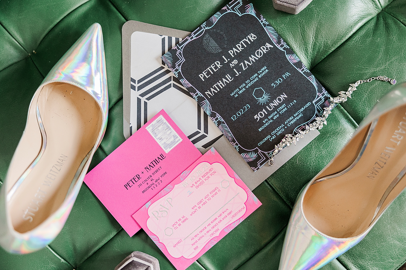 Close up shot of the bride's heels, the wedding invitation, and an rsvp card. 