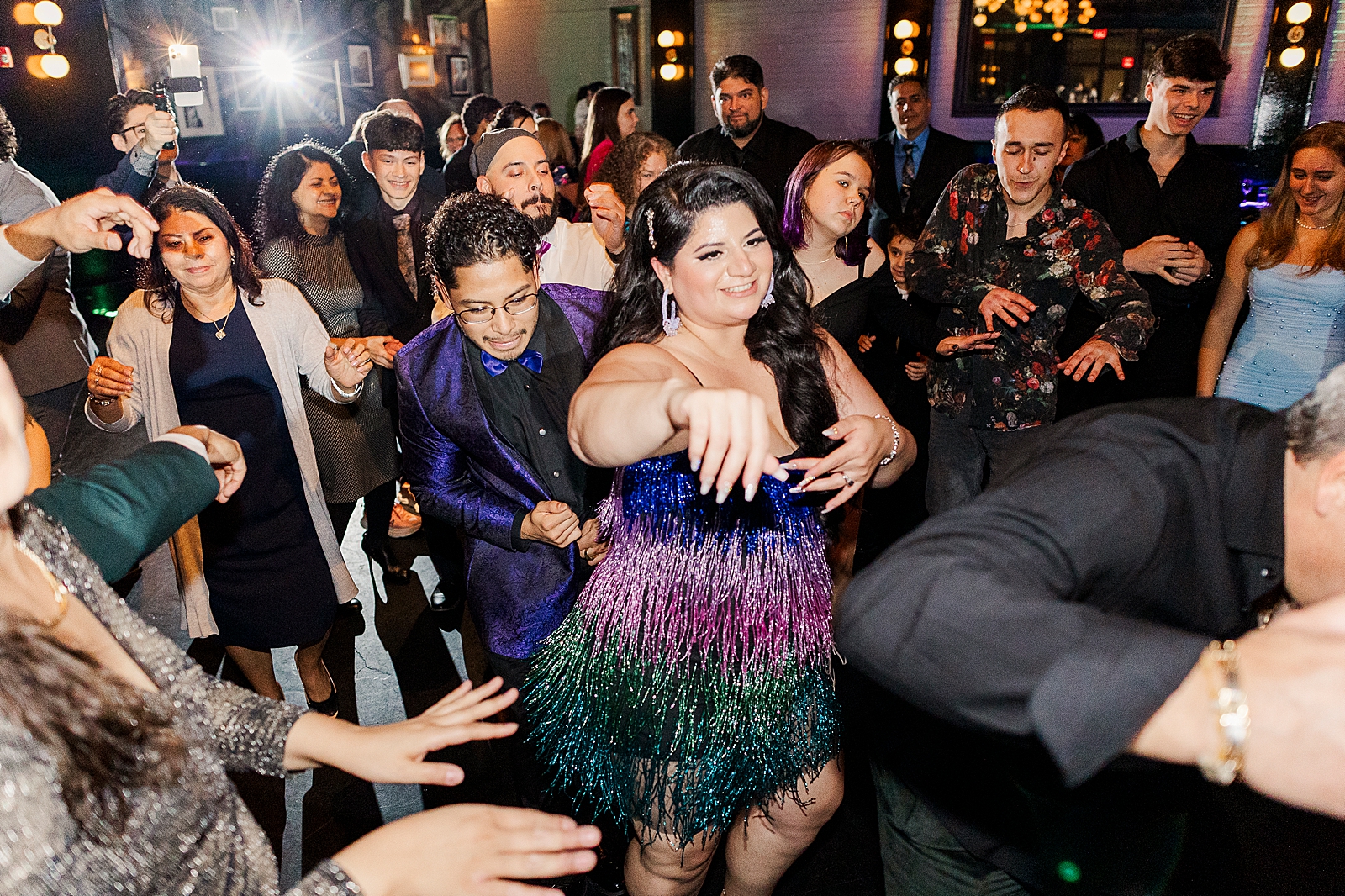 Shot of the bride having fun on the dancefloor with her guests. 