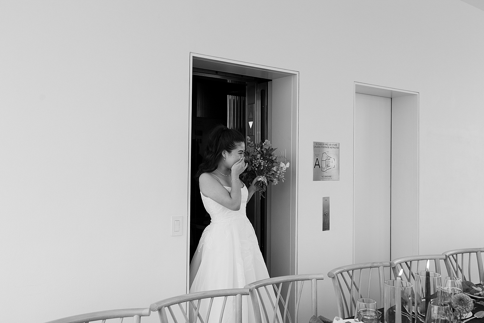 Photo of the bride looking excited as she takes in the reception space for the first time. 
